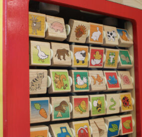 children's toy with rotating blocks illustrated with animals, plants, and random objects