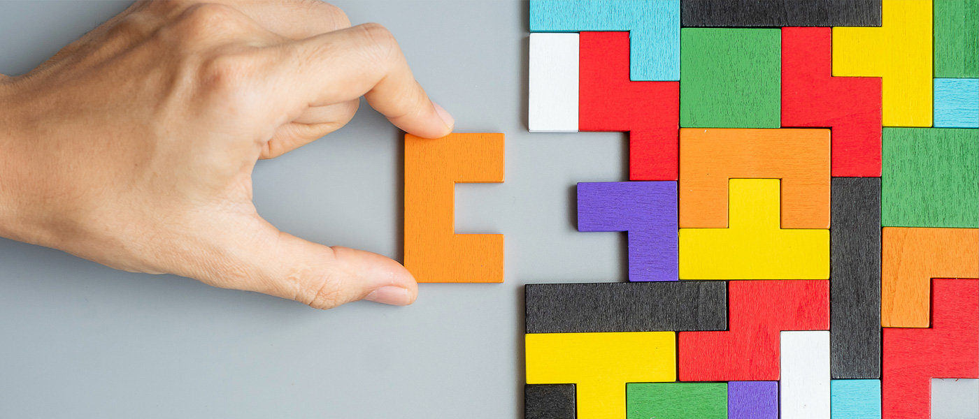 hand completing a puzzle